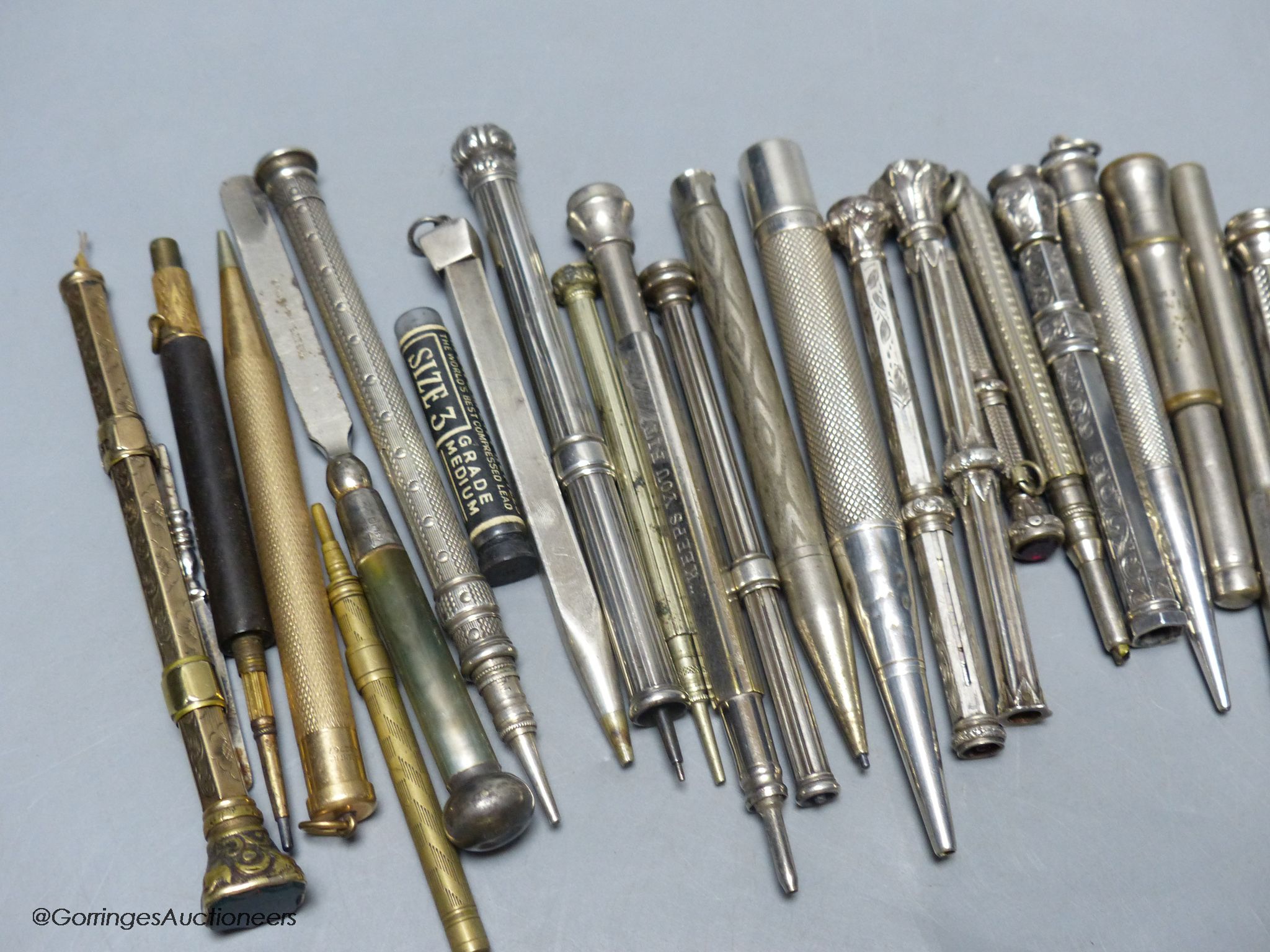 A group of silver and metal propelling pencils